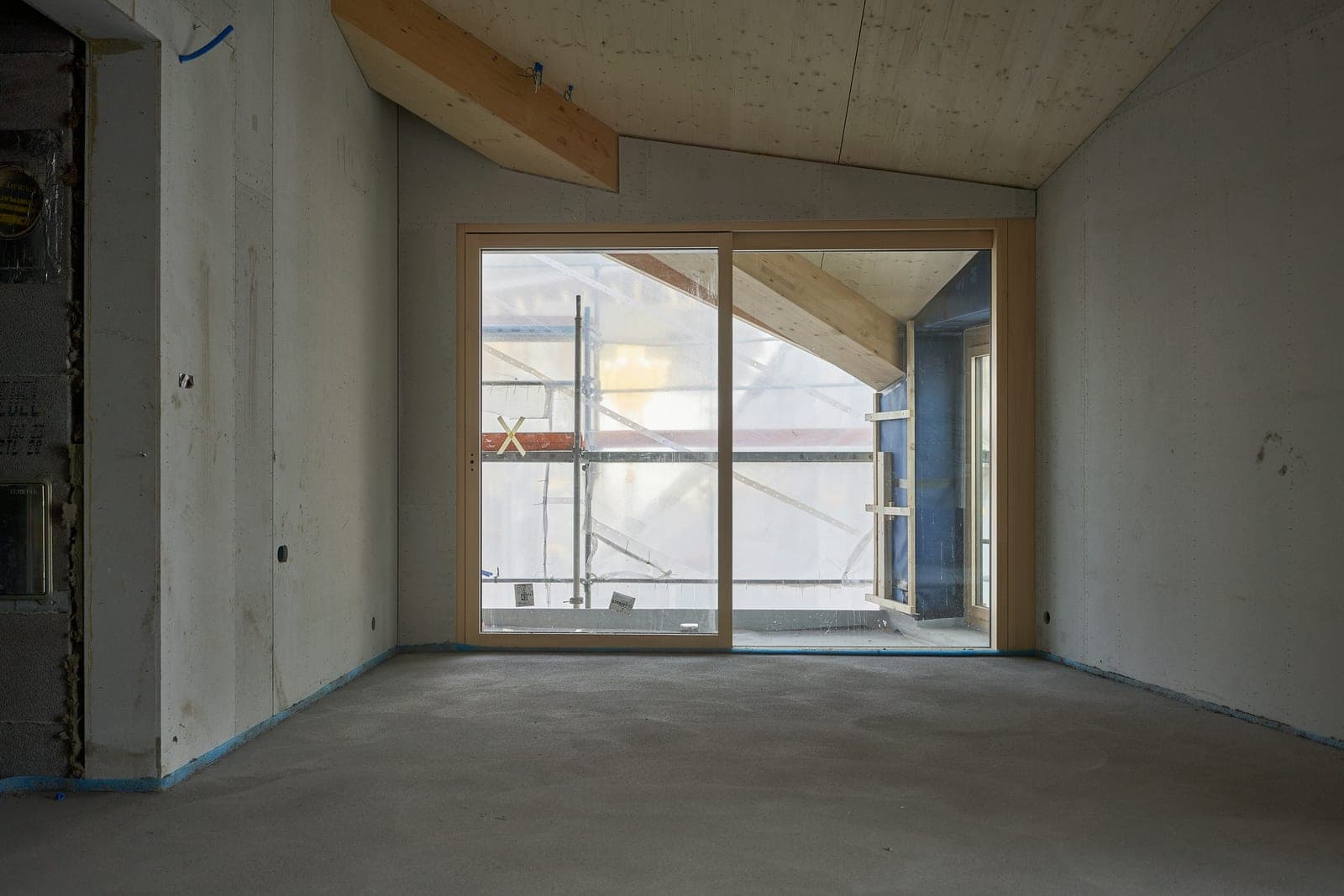 A newly built room with unfinished walls and a bare concrete floor.