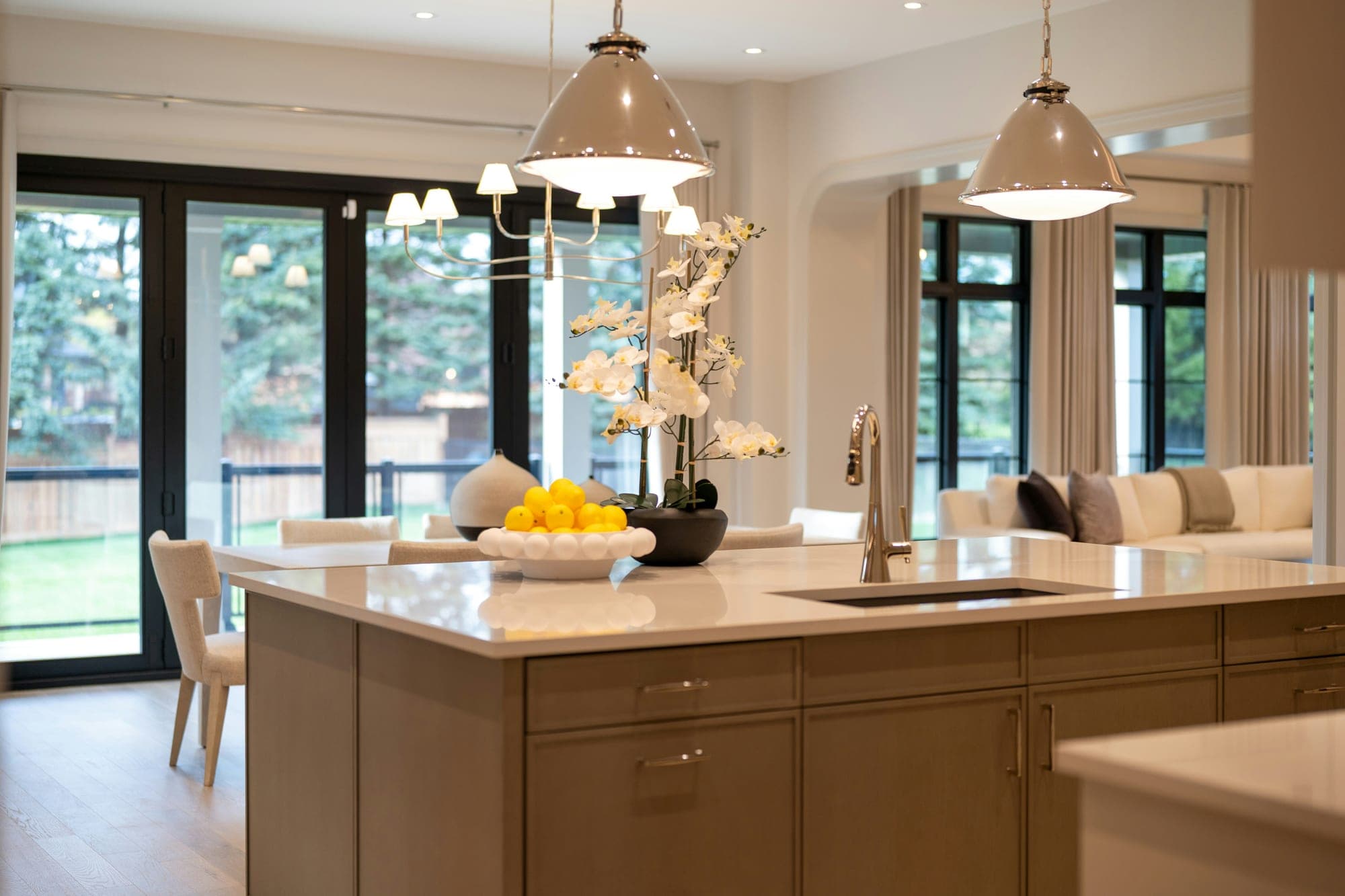 A bright, freshly cleaned kitchen with daylight coming through tall windows.